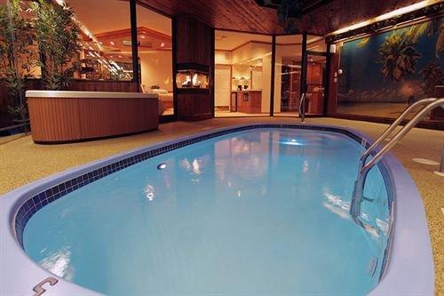 It's easy to fantasize that you and your partner have been swept away to a luxury resort when your romantic aquatic oasis with a tropical waterfall and private heated swimming pool is just a few steps away from your fully adorned bedroom complete with a relaxing massage chair and cozy fireplace.